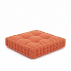 Square orange tufted floor cushion with ribbed fabric and stitched sides