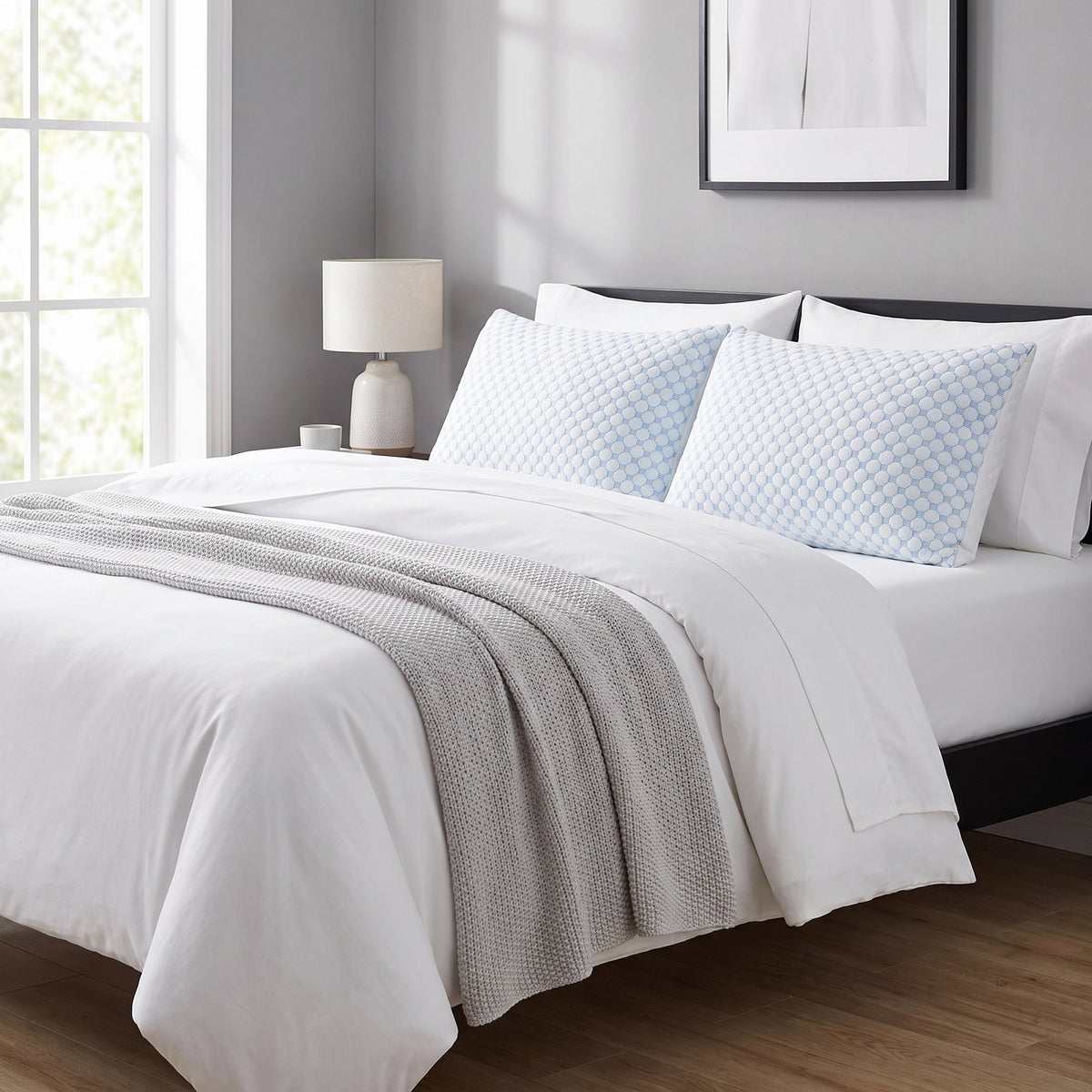 Two matching ArcticLoft king pillows on a king bed with white bedding