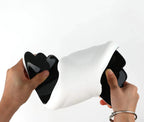 Hands bending the flexible WristWing rest to show its black underside