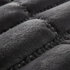 Close-up of the dark gray weighted blanket showing the stitched pockets