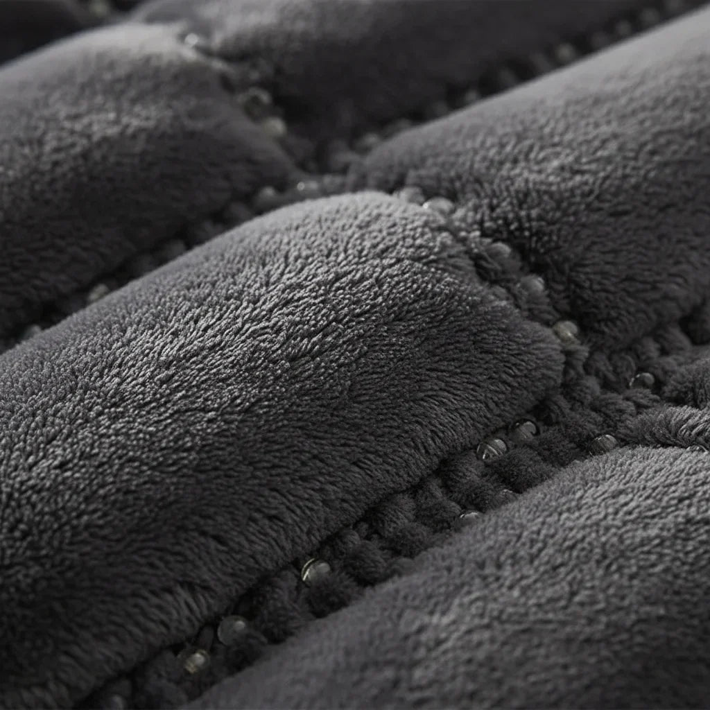 Close-up of the dark gray weighted blanket showing the stitched pockets