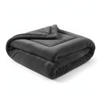 Folded dark gray GravityRest weighted blanket with soft Raschel fabric on a white background