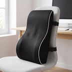 Black ErgoBack lumbar support pillow with white piping strapped to a light gray office chair