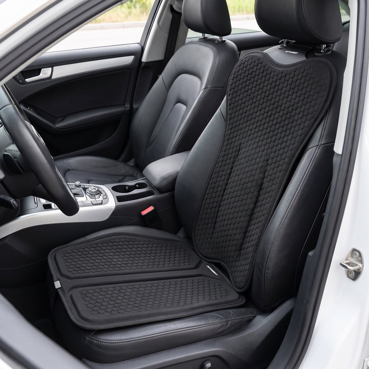 Black EaseDrive honeycomb seat pad and back cushion installed on a black leather driver's seat
