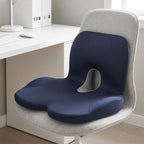 Navy ErgoWrap cushion on a light gray fabric office chair