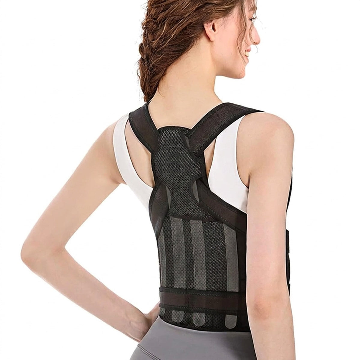 Back view of a woman wearing the black FlexBrace posture corrector with crossed shoulder straps and waist belt