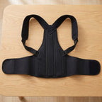 FlexBrace posture brace laid flat: shoulder straps, mesh back panel and waist belt