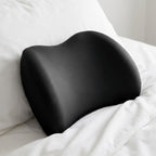 Close-up of the black NightArc lumbar pillow showing the center dip and raised sides