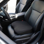 Black RideRise seat booster cushion on the black leather driver's seat of a car