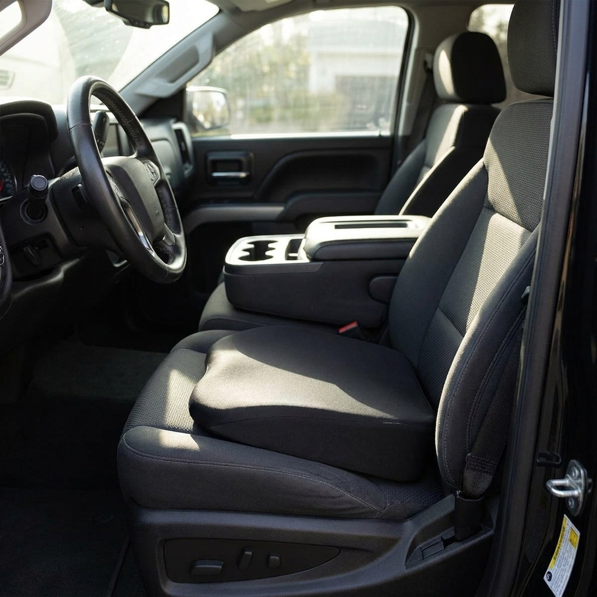 Black RideRise booster cushion on the driver's seat of a pickup truck