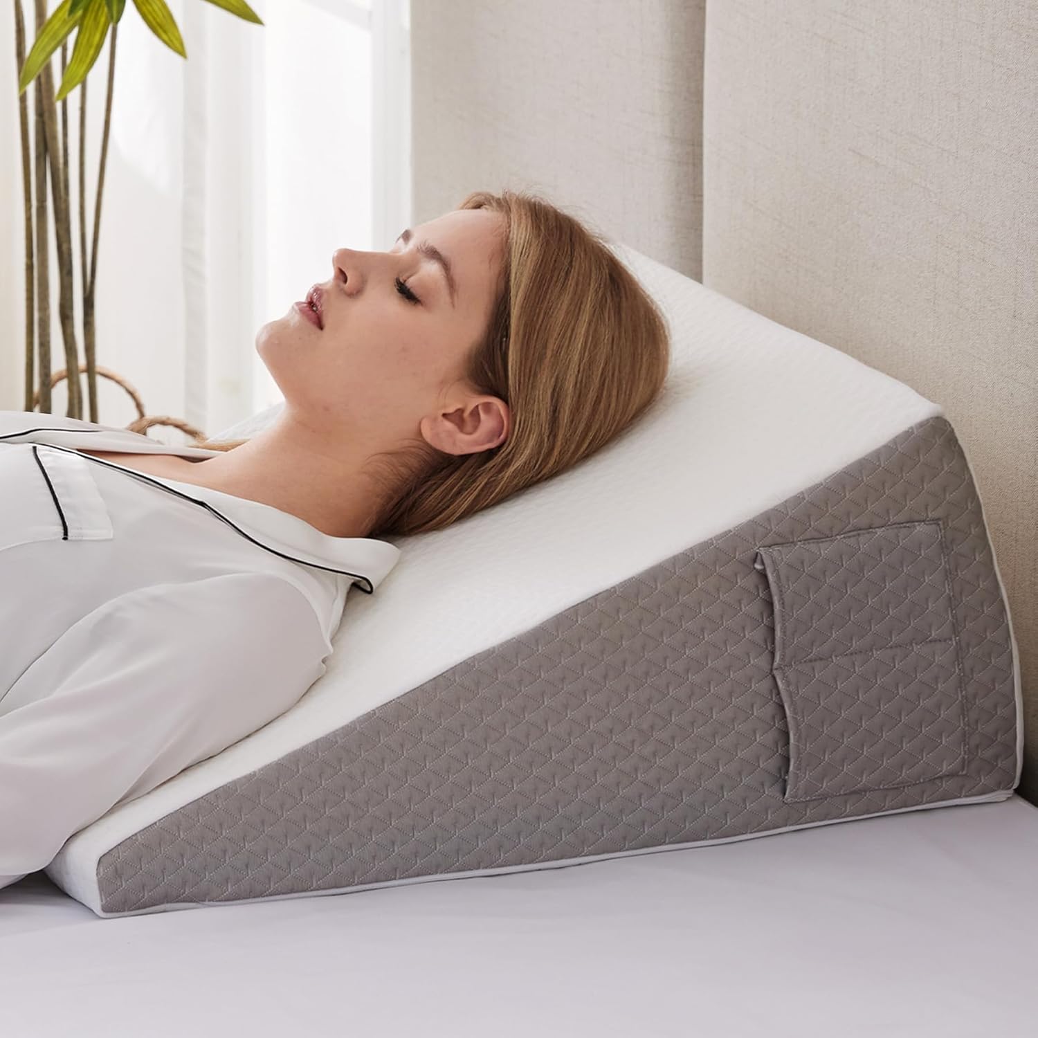 Person sleeping on SleepWell wedge pillow for elevated breathing and better sleep