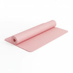 CoreFlow 8 mm pink yoga mat partly rolled up on a white background
