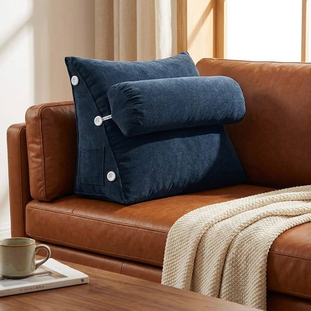 Navy WedgeRest backrest pillow on a brown leather sofa