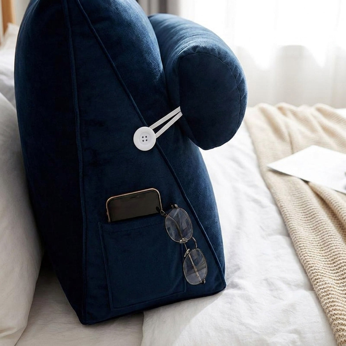 Side pocket of the WedgeRest pillow holding a phone and reading glasses